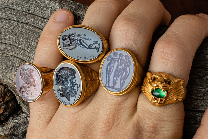 engraved gems set in gold rings on hand